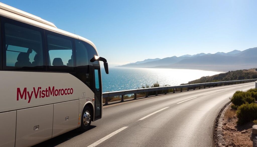 A bus traveling along a scenic coastal road in southern Spain, overlooking the sparkling waters of the Mediterranean Sea. The bus displays the logo "MyVisitMorocco" on its side, indicating it is part of a cross-border transportation service. In the distance, the rugged peaks of the Atlas Mountains are visible, hinting at the Moroccan destination. The bus is well-lit, casting long shadows across the road. The composition emphasizes the journey, with the bus occupying the foreground and the natural landscapes of Spain and Morocco framing the scene in the middle and background.