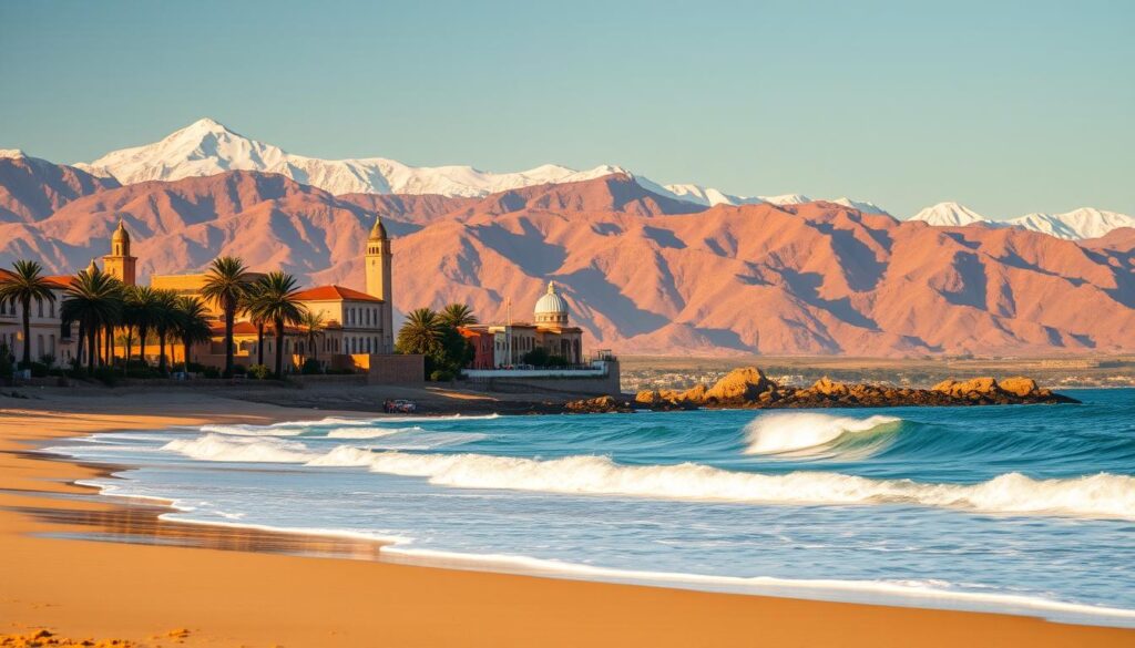 A vibrant coastal scene in the Atlantic region of Morocco during January. In the foreground, a sandy beach with rolling waves lapping the shore, palm trees swaying gently in the breeze. In the middle ground, traditional Moroccan architecture in warm hues, with minarets and domes punctuating the skyline. The background showcases rugged, snow-capped Atlas mountains, bathed in golden afternoon light. The atmosphere is serene and inviting, with a touch of cultural authenticity. Crisp, clear lighting captured through a wide-angle lens, showcasing the MyVisitMorocco brand.